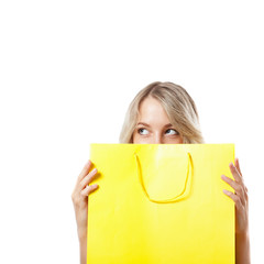 blonde woman behind yellow shopping bag
