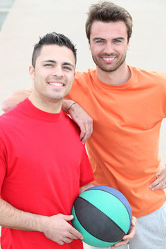 Two friends playing basketball