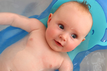 5 months baby is smiling during taking a bath