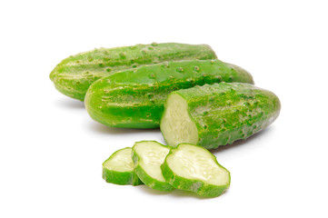 Cucumbers and slices isolated over white background.