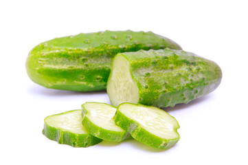 Cucumbers and slices isolated over white background.