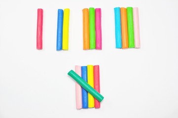colorful plasticine stick counted on white background