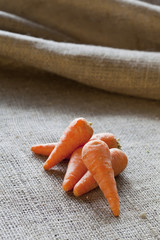 Baby carrots on sackcloth