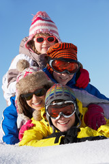 Group Of Children Having Fun On Ski Holiday In Mountains