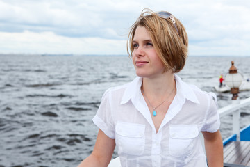 Fototapeta na wymiar Woman standing on deck of cruise ship. Copy space