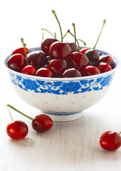Ripe cherries in a white blue bowl