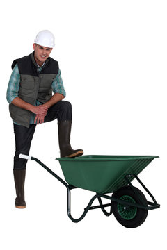 Construction worker with empty wheelbarrow