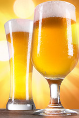 Beer in a glasses with gold background