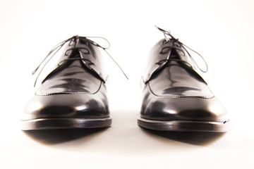 Elegant pair of black shoes for men on white