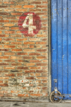 Old blue sliding door and red brick wall