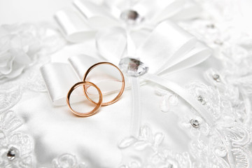 Wedding gold rings on a white pillow