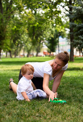 Naklejka na ściany i meble mother plays with child with toy car