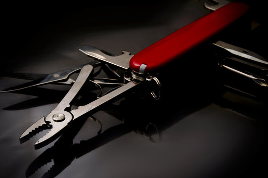 swiss knife on black background