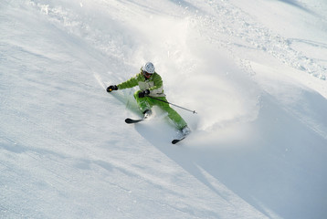 Sharp turn to ski in soft snow on the steep slope