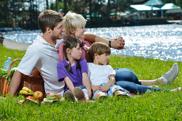 Fototapeta premium Happy family playing together in a picnic outdoors