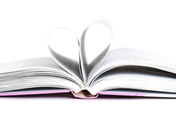 pages of a book curved into a heart shape