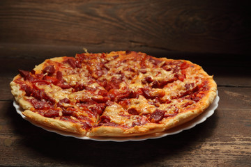 round pizza on wood background