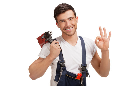 Portrait of young handyman with tool,  over white background