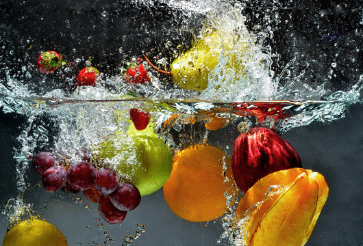 Fruit and vegetables splash into water