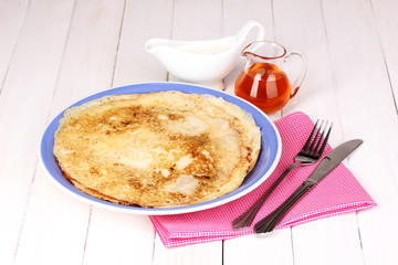 Stack of tasty pancakes on wooden background