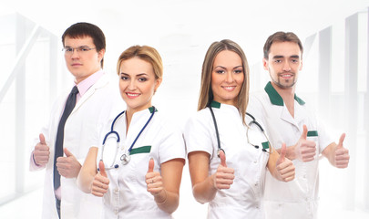 Fototapeta premium A team of young Caucasian medical workers in white clothes