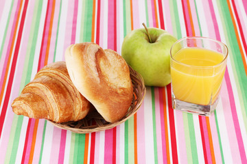 Classical breakfast. Orange juice with bun and croissant