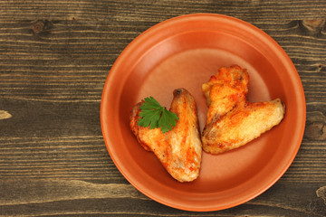 roasted chicken wings with parsley in the plate