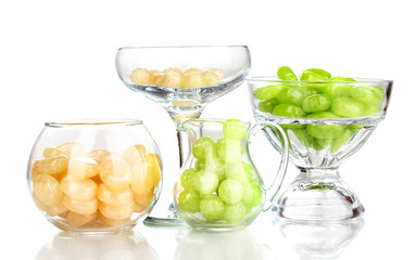 Color candies in glasses isolated on white