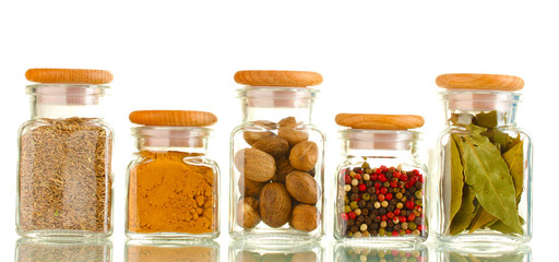powder spices in glass jars  isolated on white