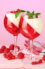 fruit jelly with berries in glasses on pink background