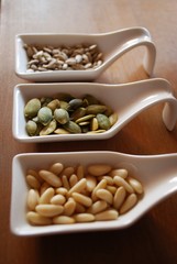 Different edible seeds in ceramic containers