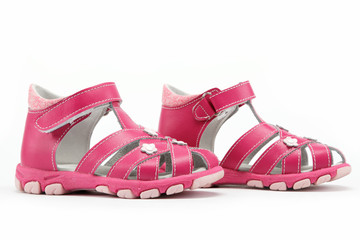 pink child's sandals isolated on white