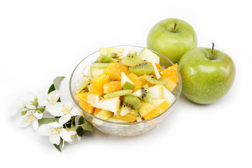 Fresh fruits salad an two apples on white background.