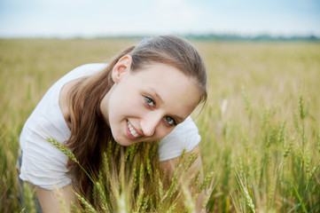 Beautiful woman smiles in field