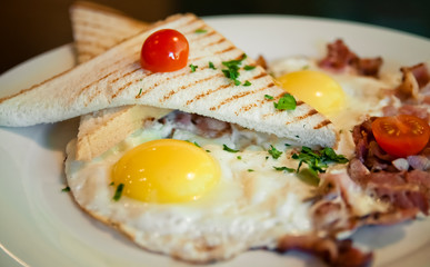 fried eggs with bacon and vegetables