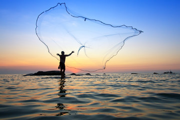 throwing fishing net during sunrise, Thailand - obrazy, fototapety, plakaty