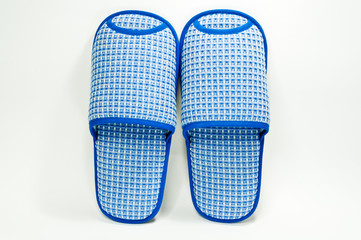 Pair of house slippers with reflection on white background