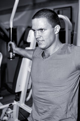 Fototapeta na wymiar Man doing athlete exercise in fitness club