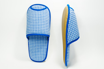 Pair of house slippers with reflection on white background