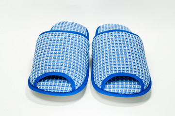 Pair of house slippers with reflection on white background