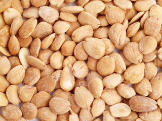 Close up of fried, peeled and salted  almonds.