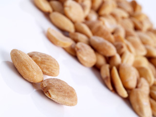 Close up of fried, peeled and salted  almonds.