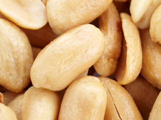 Close up of fried, peeled and salted peanuts.