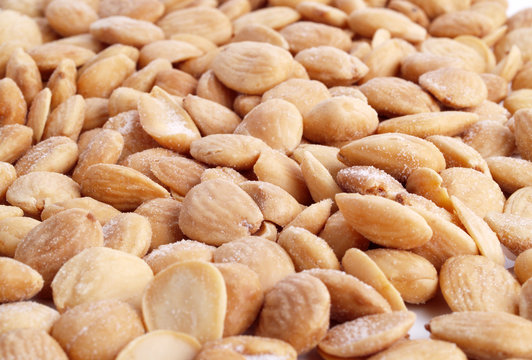 Close up of fried, peeled and salted  almonds.