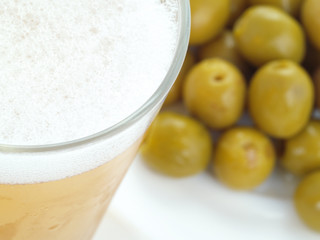 Appetizer with cold beer and green olives.