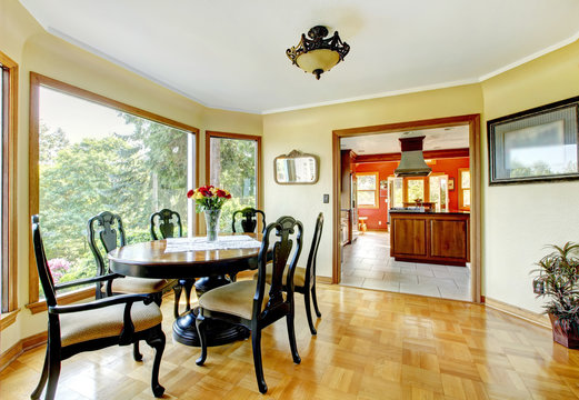 Dining room with yellow walls and hardwood floor interior.
