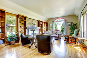 Large living room with firepalce and hardwood floor.