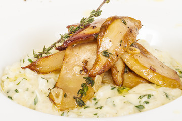 photo of delicious risotto dish with herbs and mushrooms on whit