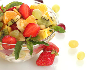 glass bowl with fresh fruits salad and berries isolated on