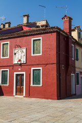 The row of colorful houses in Burano street, Italy.